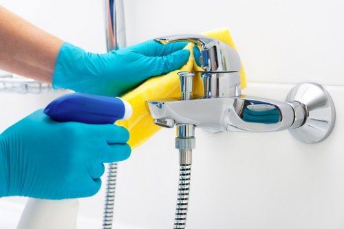 Worker using safe manual handling techniques with carpet cleaning equipment