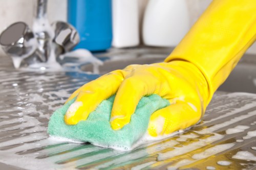 Cleaning team preparing equipment near a carpeted room